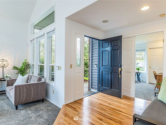 Spacious entry with gleaming hardwood floors.