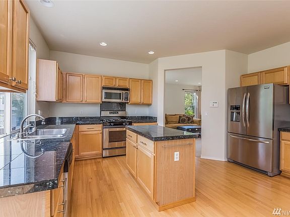A Chef's Dream! This large kitchen is perfect for entertaining with it's Maple floors & cabinets, stainless steel appliances, granite countertops, and plenty of storage.