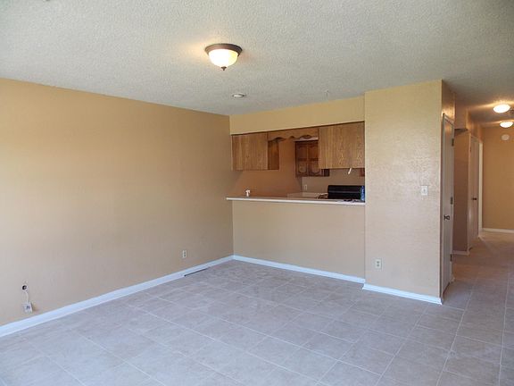 Living room with passthru to kitchen. Ceramic tile throughout.
