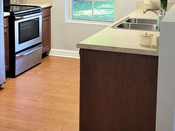 Kitchen equipped with stainless steel appliances. Dishwasher - Electric Range - Refrigerator