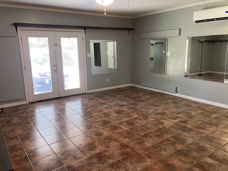 Bonus room (double doors lead out to driveway/carport/front of house)