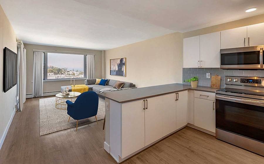 Limited availability: newly renovated Finish Package II apartment homes featuring kitchens with grey quartz countertops, white cabinetry, stainless steel appliances, grey tile backsplash, and hard surface flooring
