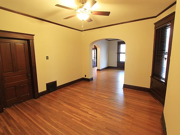 Large dining room and living room with wood floors.