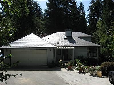 Front view showing Interlock metal roof and covered porch 