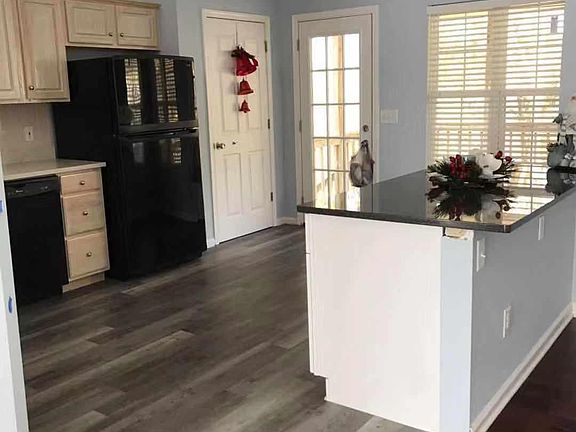 Kitchen with pantry and door to outdoor patio