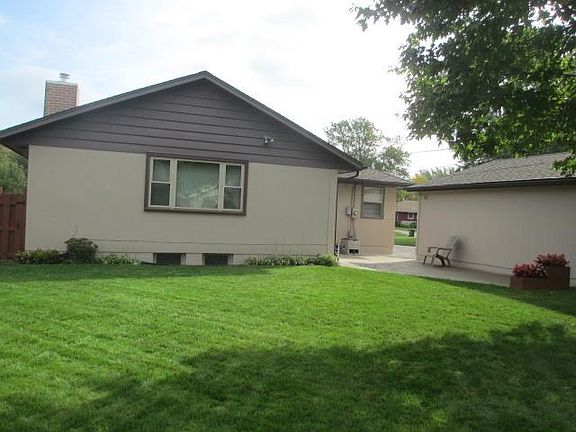 Rear view of the home with a nice sized patio and access to the family room.
