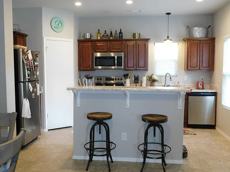 Great kitchen with newer wood look LVP flooring (not shown in photos). Convenient breakfast bar. Stainless steel appliances.