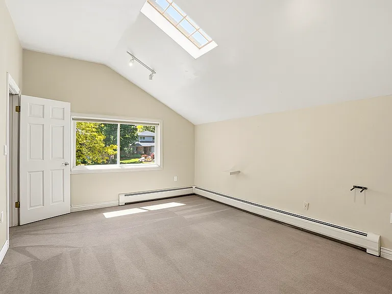 Like the other bedrooms in the home, this inviting space offers its own unique character, highlighted by a skylight that fills the room with natural light by day and views of the night sky after dark.