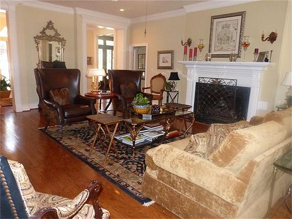 Large Family Room with hardwood floors and raised mantel gas log fireplace.