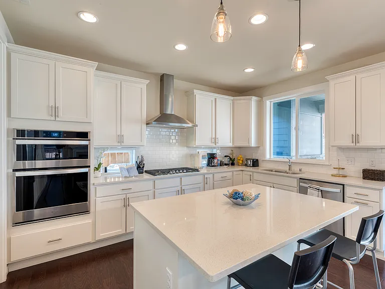 Modern Kitchen cabinets with quartz countertop. Stainless steel appliances