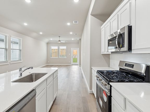 Kitchen in the Elm home plan by Trophy Signature Homes - REPRESENTATIVE PHOTO