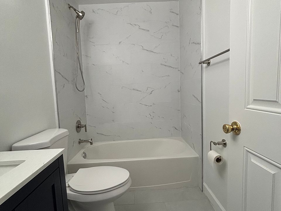 Bathroom has a new vanity/sink, new bathroom fixtures, and new shower/tub wall.
