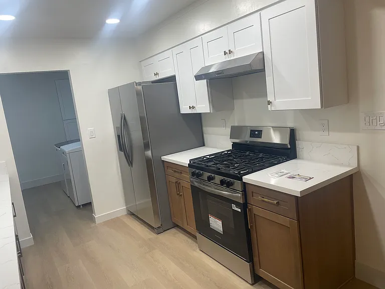 Kitchen featuring quartz countertops, custom cabinetry, Delta fixtures, and recessed dimmable lighting