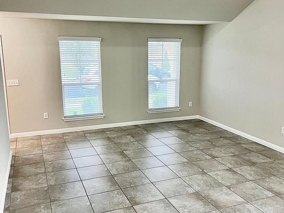Living room is huge with high ceilings, upgraded tile flooring and lots of great natural light.