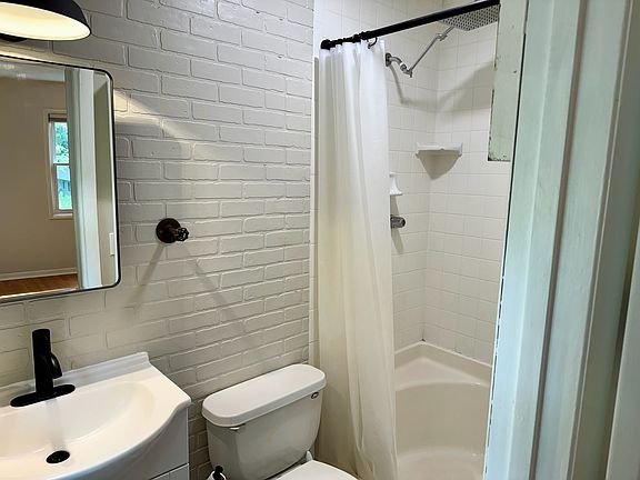 Primary bedroom ensuite has stand up shower, medicine cabinet, sink and toilet