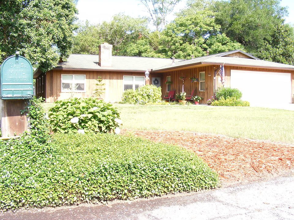 Cedar-sided home with trees