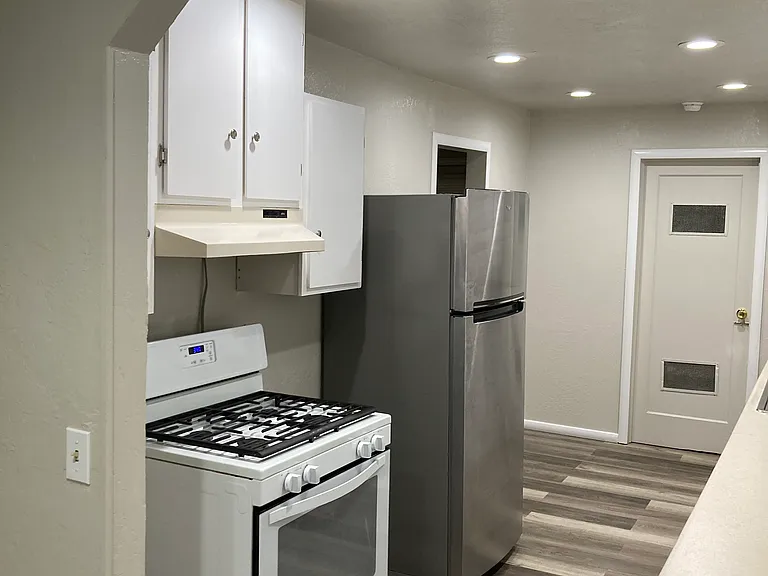 Kitchen,gas stove, stainless steel refrigerator inset lights, lots of cabinets