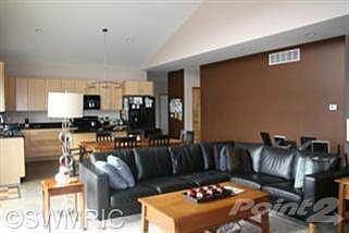 Great room with vaulted ceiling,window wall and atrium doors to patio