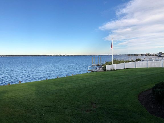 View of a lighthouse, and of the beach in the distance. One