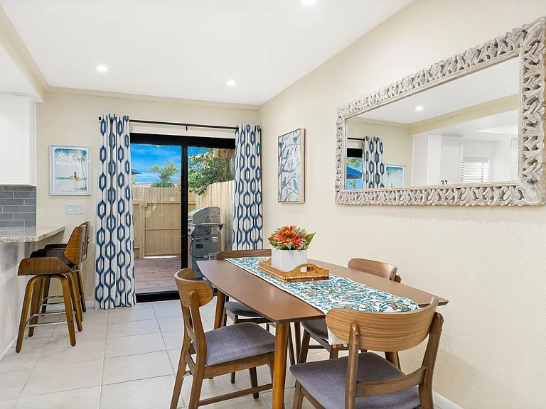 Dining area with kitchen on left and back patio straight ahead.