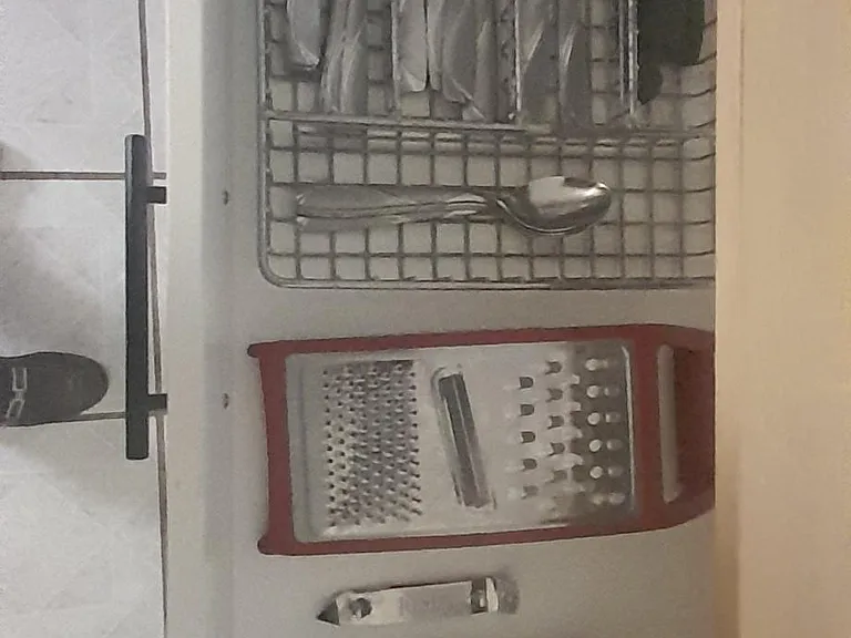 The dining utensils are in the drawer of the dining table.