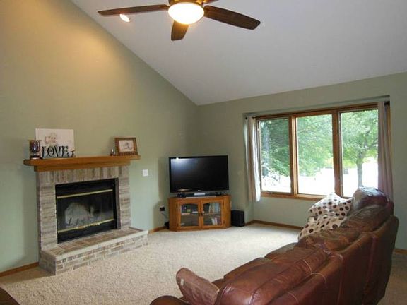 Once inside, the main living area will impress you with its vaulted ceiling and fireplace.
