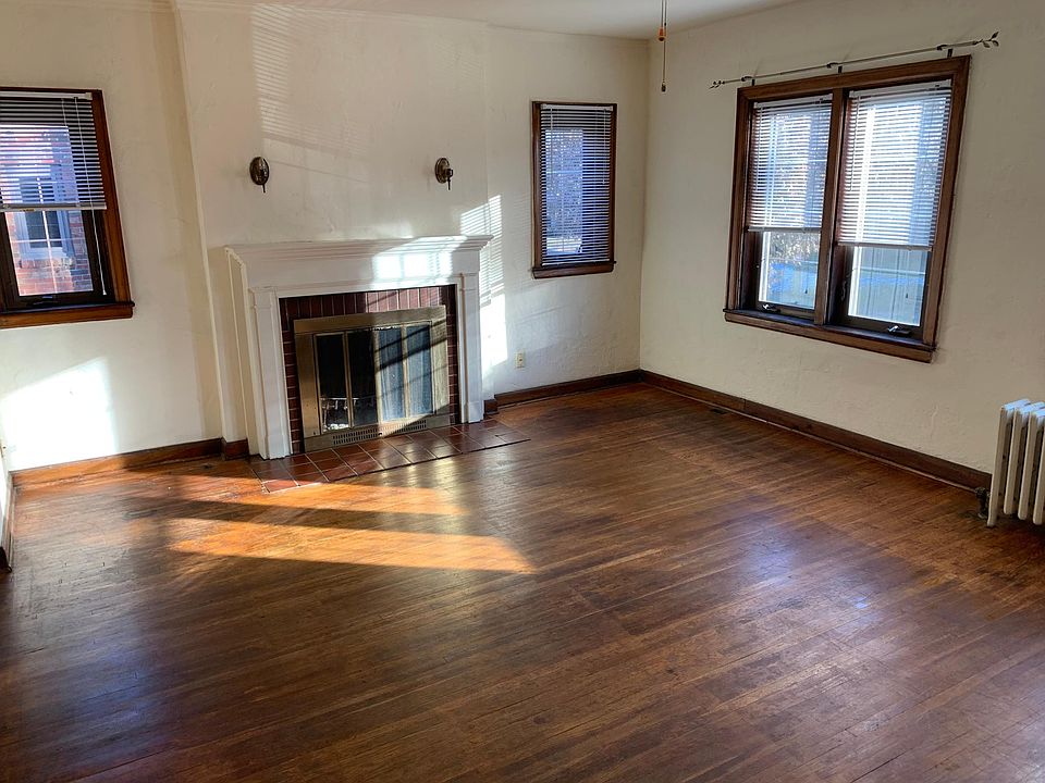 Living room with wood burning fireplace.
