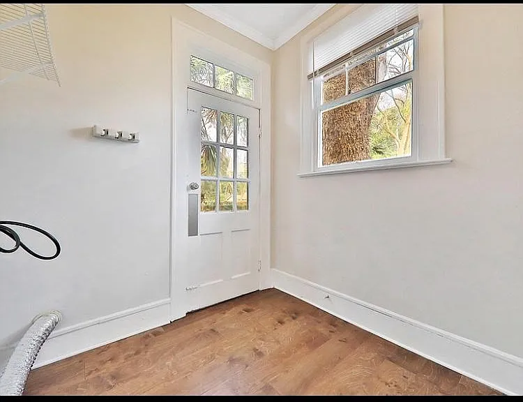 Separate laundry room off the kitchen with back door entrance