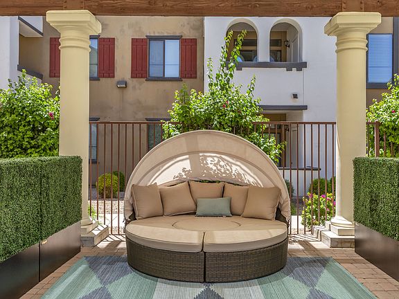 Enjoy our inviting patio, complete with a comfy couch and rug, perfect for unwinding outdoors