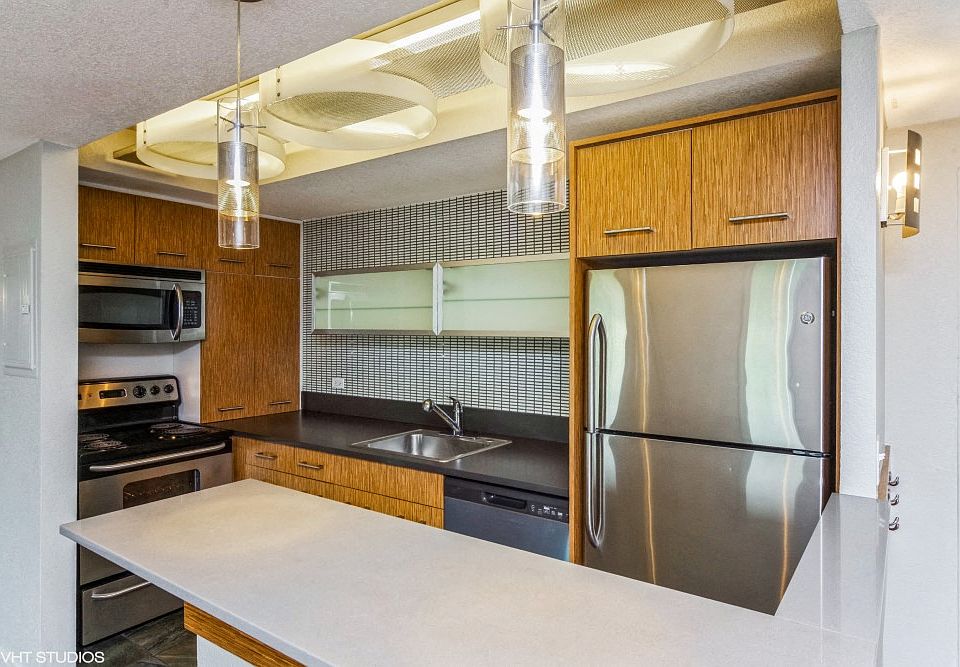 Kitchen with stainless steel appliances and a breakfast bar