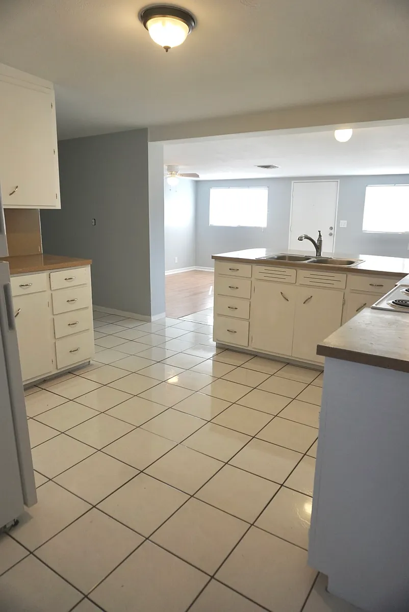 Kitchen with secondary living room in background - 833 W Howe St