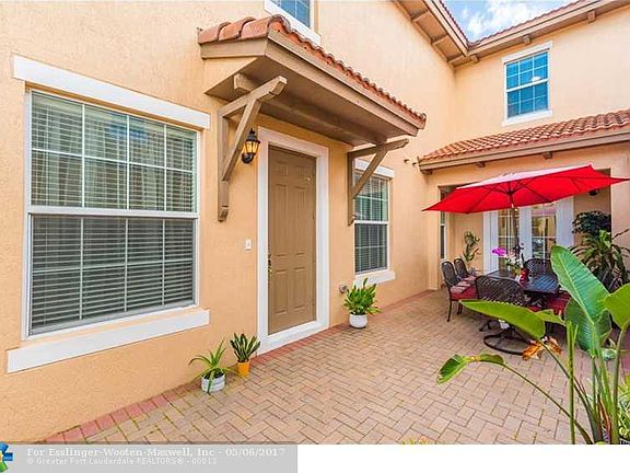 Impressive Mediterranean Inspired Town Home In Highly Desired West Pembroke Pines Gated Community.