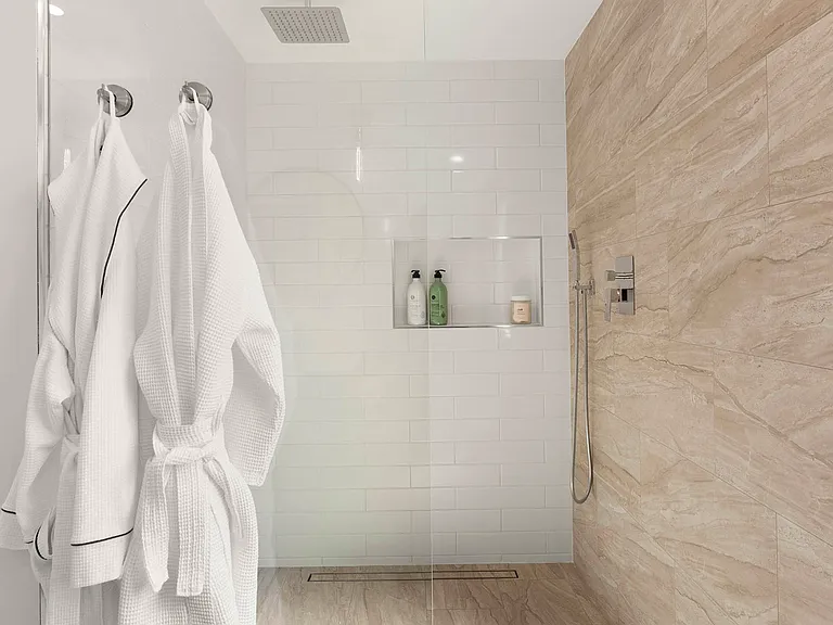 Primary en-suite spa bathroom with rain shower.