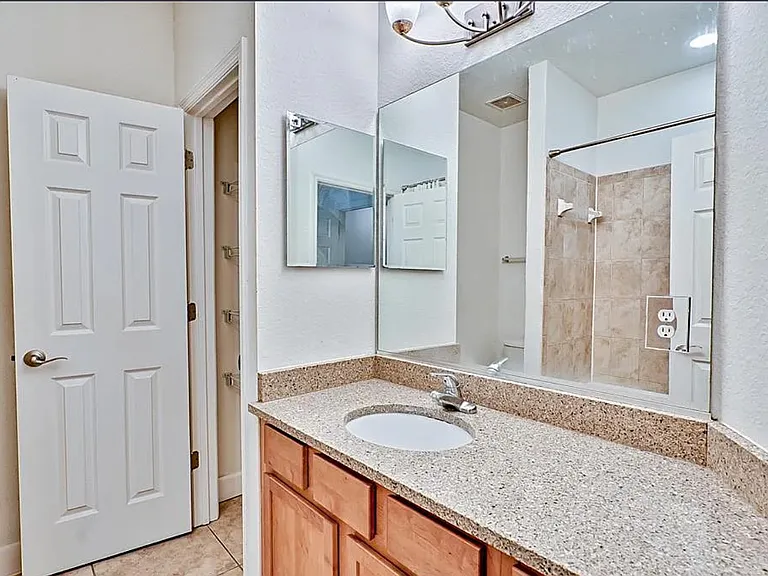Primary en-suite bathroom with storage closet