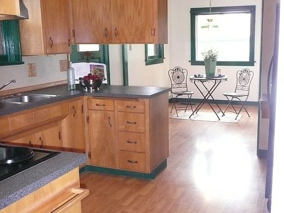 The refurbished kitchen includes a cozy breakfast nook.