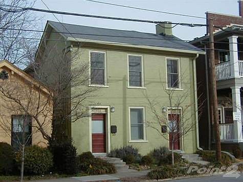 To the right is Nick Ryan's, to the left is a brick "shot gun" house.