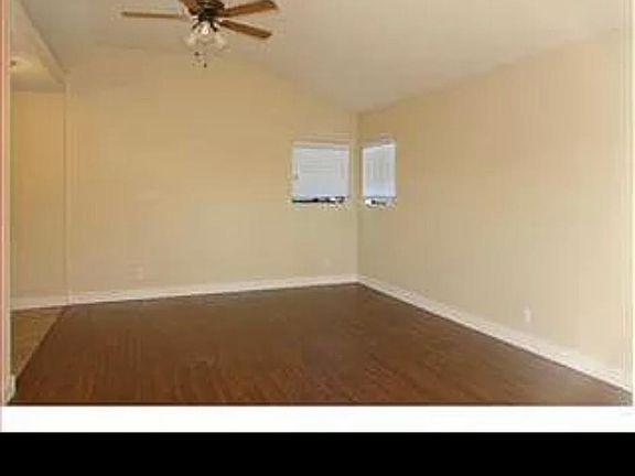 Spacious, well lit kitchen/dining area with windows on three sides, garden setting opens onto private patio.