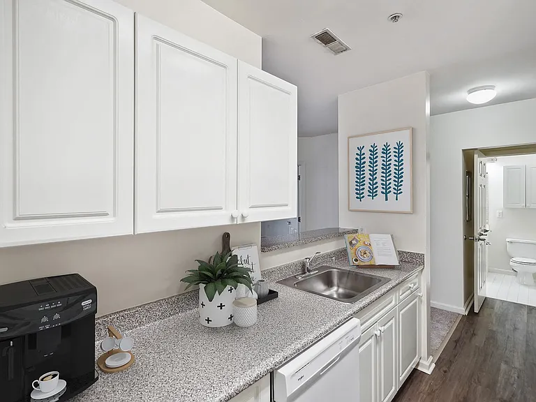 Kitchen with white cabinets and appliances