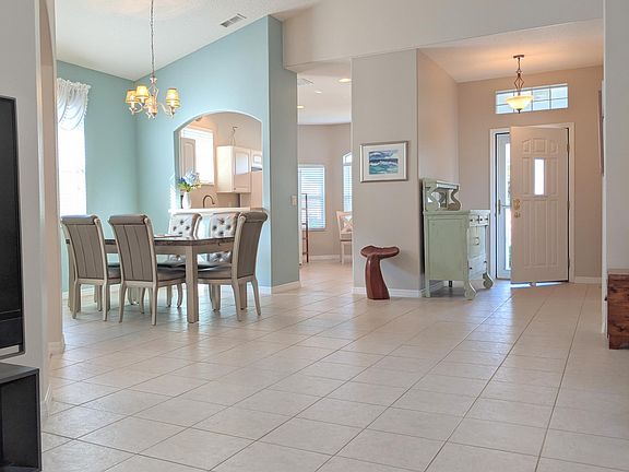 Living room towards dining room, kitchen, front door