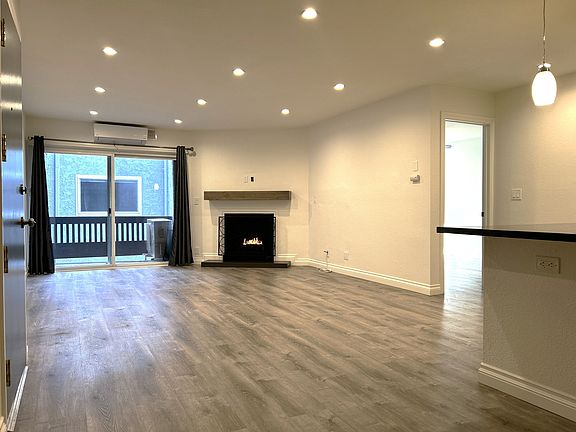 Fireplace and slider to small balcony