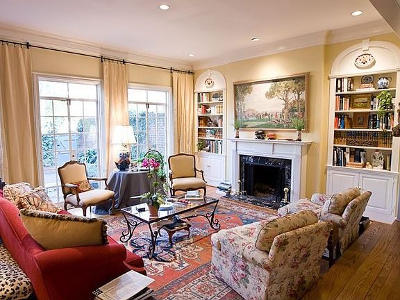 FORMAL LIVING ROOM W WALL OF FRENCH DOORS OPENING TO PRIVATE, WALLED GARDEN