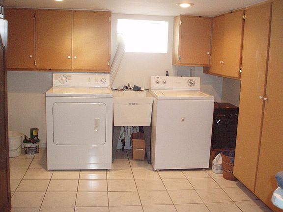 Tile basement/laundry and built in storage.