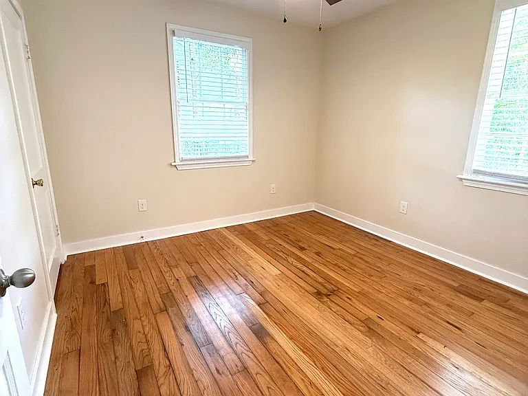 Bedroom #3 with windows facing side and back yard