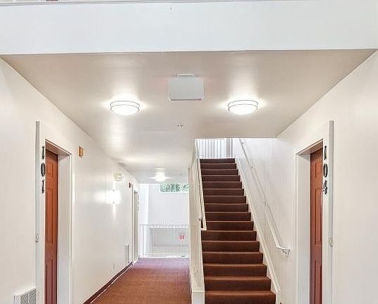 Inside Building entrance, one flight of stairs to unit