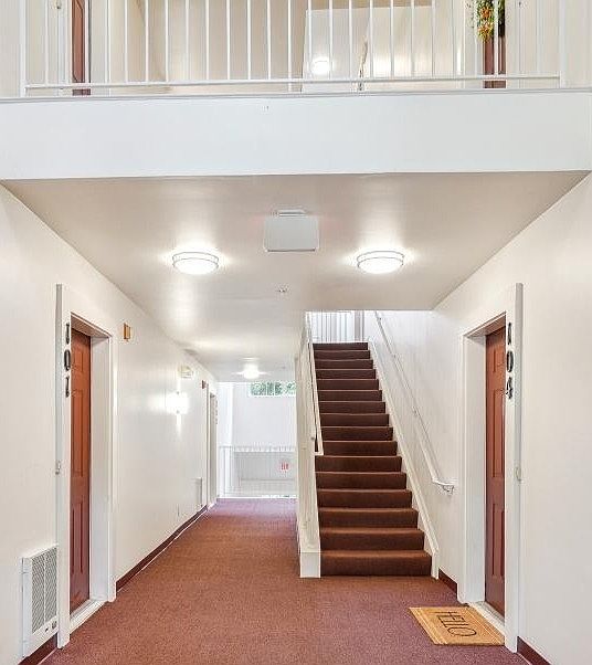 Inside Building entrance, one flight of stairs to unit