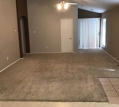 Living Room from Dining Room Sliding glass door to backyard and patio behind vertical blinds