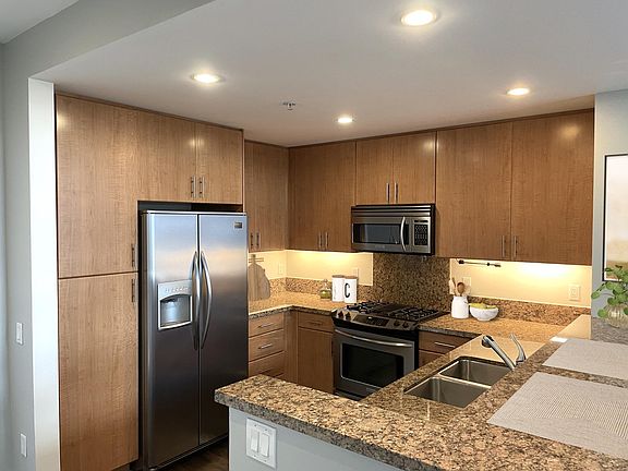 Kitchen with gas stove, garbage disposal, dishwasher, microwave, granite