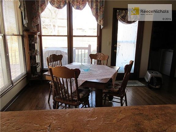 Breakfast area surrounded by windows and access to large deck. Laundry room to the right.
