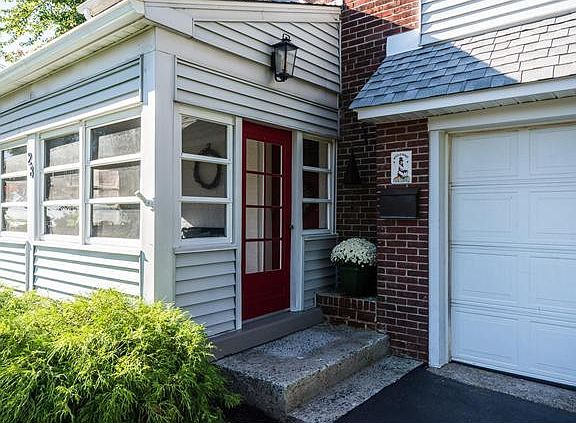 Charming enclosed porch ushers you inside!