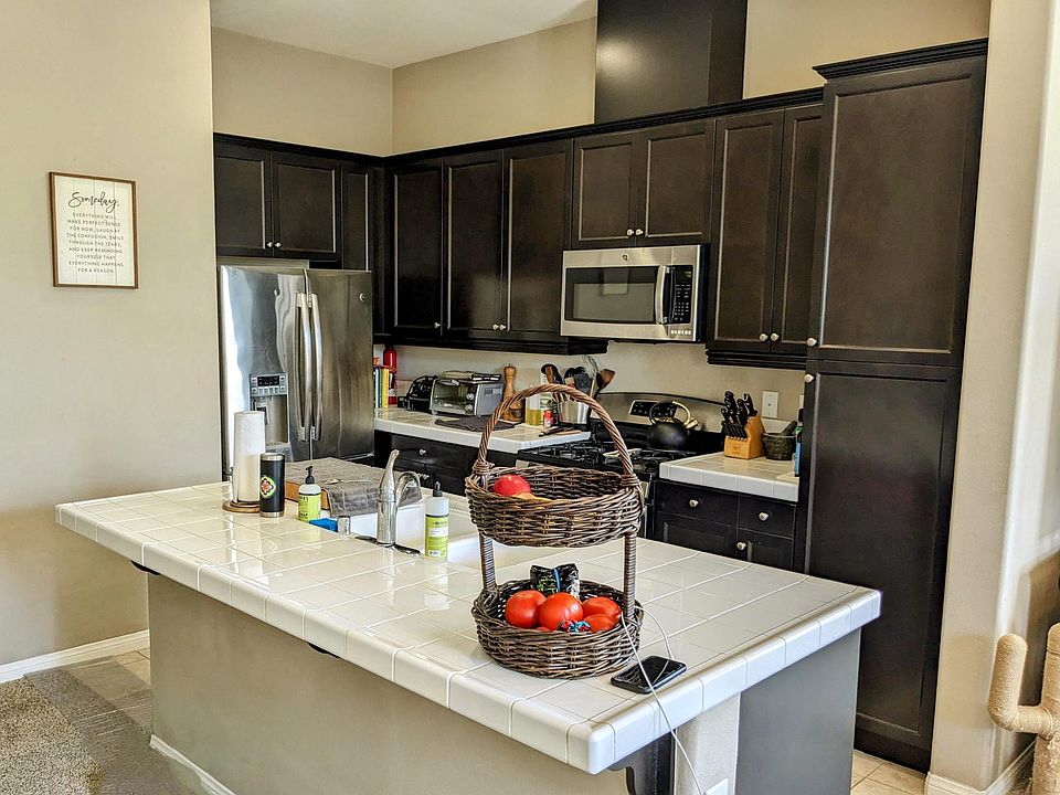 Kitchen w stainless appliances, gas stove and Island